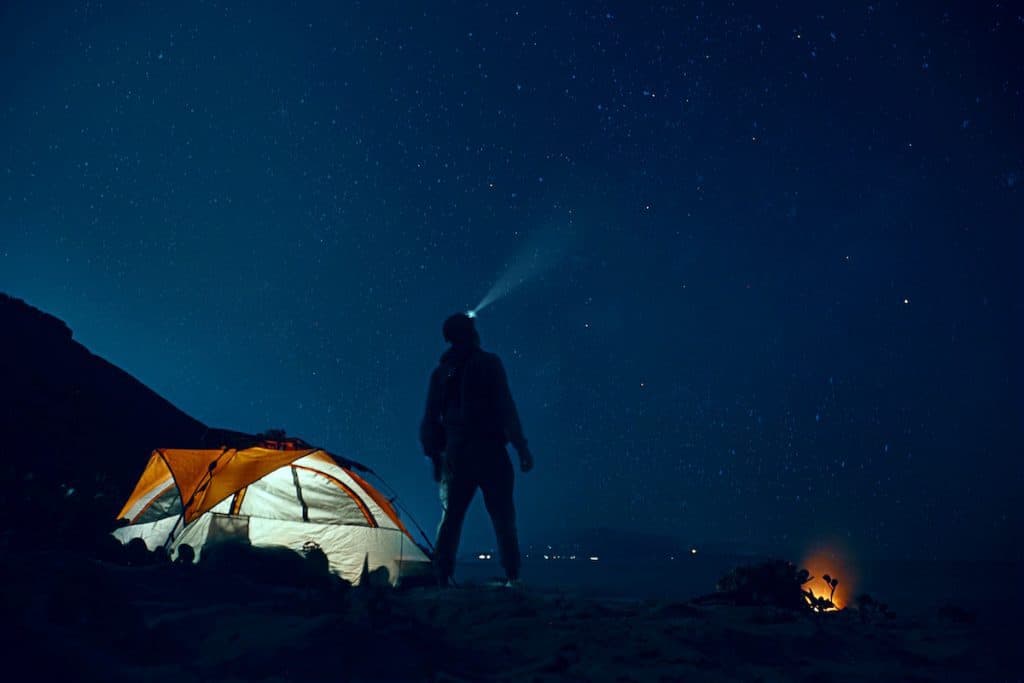 solo camper looking out the sky